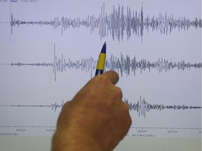 A seismologist looks at the data following a strong earthquake in the South Pacific in 2009.