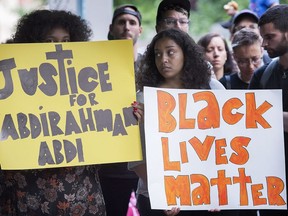 People gather in Montreal, Thursday, July 28, 2016, to denounce the death of Abdirahman Abdi in Ottawa.