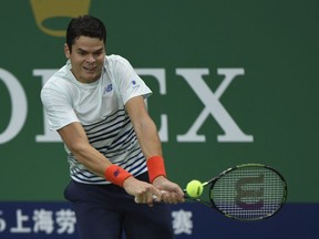 Milos Raonic of Canada returns a shot to Jack Sock of United States during the Men's singles third round match on day five of Shanghai Rolex Masters at Qi Zhong Tennis Centre on October 13, 2016 in Shanghai, China.