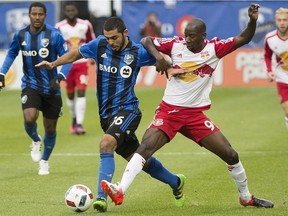 Montreal Impact's Victor Cabrera, left, challenges New York Red Bulls' Bradley Wright-Phillips during first half action of the first leg of the Eastern Conference MLS soccer semifinal in Montreal, Sunday, Oct. 30, 2016.