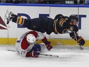 Buffalo Sabres Josh Gorges (4) collides with Montreal Canadiens forward Torrey Mitchell (17) during the third period of a NHL hockey game, Thursday, Oct. 13, 2016, in Buffalo, New York.