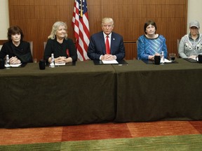 Republican presidential candidate Donald Trump, sits with, from right, Paula Jones, Kathy Shelton, Juanita Broaddrick, and Kathleen Willey, before the second presidential debate with democratic presidential candidate Hillary Clinton at Washington University, Sunday, Oct. 9, 2016, in St. Louis.