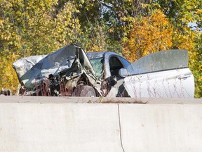 A wrecked car sits on Highway 30 in Candiac, southwest of Montreal, after it hit a concrete median during a police chase involving the Sûreté du Québec Oct. 10, 2016.