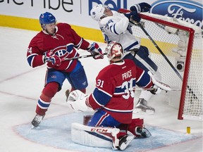 Toronto Maple Leafs' Auston Matthews (34) collides with the net of Montreal Canadiens goaltender Carey Price as Canadiens' Alexei Emelin (74) defends during first period NHL hockey action in Montreal, Saturday, Oct. 29, 2016.