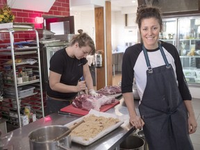 Charline Labonté, right, former goaltender for the Canadian Olympic hockey team, helps out chef Vanessa Trahan in her restaurant Wednesday, October 19, 2016 in Montreal. Labonté has traded in her goaltending equipment for an apron and chef's hat.