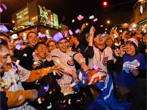 Chicago Cubs fans celebrate outside of Wrigley Field after Game 5 of the Major League Baseball World Series against the Cleveland Indians, Sunday, Oct. 30, 2016, in Chicago. The Cubs won 3-2 as the Indians lead the series 3-2.