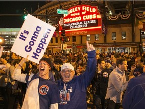 Cubs fans celebrate outside Wrigley Field after Chicago defeated the Los Angeles Dodgers 5-0 in Game 6 of baseball's National League Championship Series on Saturday, Oct. 22, 2016. The Cubs advanced to the World Series.