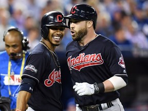 Cleveland Indians' Jason Kipnis, right, celebrates with teammate Francisco Lindor after hitting a solo home run against the Toronto Blue Jays during sixth inning game three American League Championship Series baseball action in Toronto on Monday, October 17, 2016.