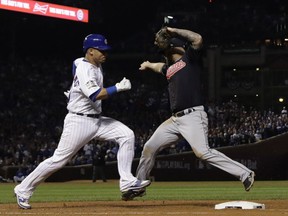 Cleveland Indians' Mike Napoli beats Chicago Cubs' Willson Contreras to first during the seventh inning of Game 3 of the Major League Baseball World Series Friday, Oct. 28, 2016, in Chicago.