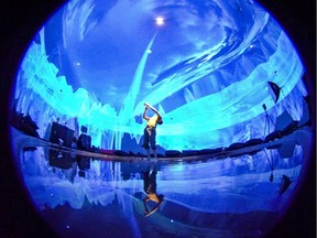 Peter Trosztmer performs solo around a pool of water in the Satosphere where his gestures create changing images all around him thanks to motion-capture technology.