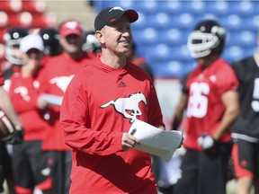 Coach Dave Dickenson watches over the opening session of training camp for the Calgary Stampeders in Calgary, Sunday, May 29, 2016.
