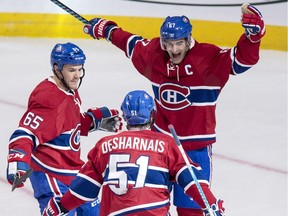 Montreal Canadiens' David Desharnais celebrates his goal against the Pittsburgh Penguins with teammates Max Pacioretty, right, and Andrew Shaw during second period NHL hockey action Tuesday, October 18, 2016 in Montreal.