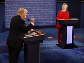 Democratic presidential nominee Hillary Clinton smiles as Republican presidential nominee Donald Trump speaks during the presidential debate at Hofstra University in Hempstead, N.Y., Monday, Sept. 26, 2016.