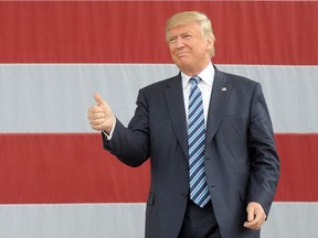 Republican presidential nominee Donald Trump gives the thumbs up during a campaign event on October 14, 2016 in Greensboro, North Carolina. Trump claimed journalists are actually lobbyists and the recent accusations against him were generated by the media.