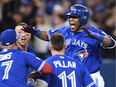 Toronto Blue Jays' Edwin Encarnacion celebrates his walk-off three-run home run during 11th inning American League wild-card game action against the Baltimore Orioles in Toronto, Tuesday, Oct. 4, 2016.