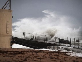 Waves crash ashore as Hurricane Matthew approaches the area on October 6, 2016 in Singer Island, Florida.  The hurricane is expected to make landfall sometime this evening or early in the morning as a possible Category 4 storm.