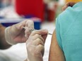 A vaccine is administered to a patient.