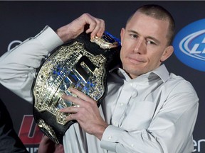 Welterweight UFC champion Georges St-Pierre put his belt on his shoulder during a news conference in Montreal on January 23, 2013. Former UFC welterweight champion Georges St-Pierre says he's ready to return to the octagon.The 35-year-old Canadian fighter told the podcast 'MMA Hour' that he's ready to come out of retirement in an interview on Monday.