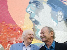Singer-songwriter Gilles Vigneault, left, talks with artist Laurent Gascon during the unveiling of a mural in Vigneault's honour in Montreal, Thursday, October 6, 2016.