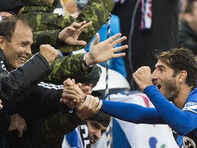 Montreal Impact's Ignacio Piatti celebrates with fans after scoring against Toronto FC during second half MLS soccer action in Montreal on Sunday, Oct. 16, 2016.