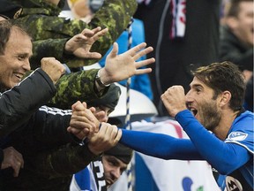 Montreal Impact's Ignacio Piatti celebrates with fans after scoring against Toronto FC during second half MLS soccer action in Montreal, Sunday, October 16, 2016.