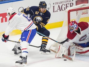 Buffalo's Marcus Foligno tries to avoid Montreal's Shea Weber during a wrap around attempt on Montreal goaltender Al Montoya during the season opener between the Sabres and the Canadiens at the KeyBank Centre in Buffalo, New York, October 13, 2016.