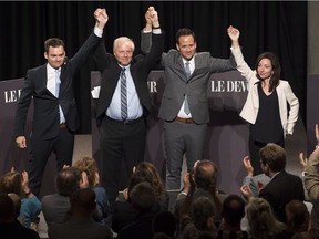 Parti Québécois leadership candidates Paul Saint-Pierre Plamondon, left, Jean-François Lisée, Alexandre Cloutier and Martine Ouellet in a moment of solidarity at the end of Monday’s debate at the Musée de la civilisation in Quebec City.