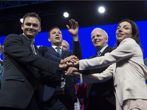 The new Parti Québécois leader Jean-François Lisée, third from left, poses with candidates Paul St-Pierre Plamondon, left, Alexandre Cloutier and Martine Ouellet after his acceptance speech at the Parti Québécois leadership race results evening, Friday, Oct. 7, 2016 in Lévis.