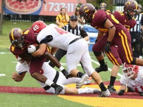 After five concussions, Karl Forgues, centre, in white, finally called it quits, ending a promising football career.