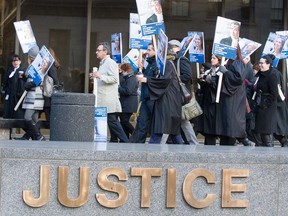 Quebec lawyers and notaries march at the Montreal courthouse as part of the first day of a general strike Oct. 24, 2016.