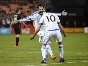 Montreal Impact forward Matteo Mancosu, back, celebrates his goal with Ignacio Piatti (10) during the first half of an MLS playoff soccer match against D.C. United, Thursday, Oct. 17, 2016, in Washington.