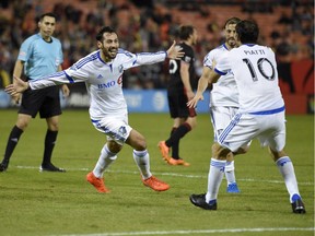 Montreal Impact forward Matteo Mancosu, front left, celebrates his goal with Ignacio Piatti (10) during the first half of an MLS playoff soccer match against D.C. United, Thursday, Oct. 27, 2016, in Washington.