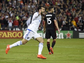 Montreal Impact forward Matteo Mancosu, left, celebrates his goal as D.C. United defender Steve Birnbaum (15) looks on during the first half of an MLS playoff soccer match, Thursday, Oct. 27, 2016, in Washington.