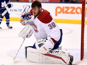 Montreal Canadiens goaltender Mike Condon (39) loses his helmet after making a save during second period of NHL hockey pre-season action against the Toronto Maple Leafs in Toronto on Sunday, October 2, 2016.