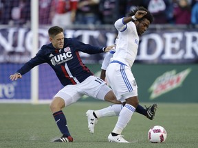 New England Revolution midfielder Kelyn Rowe, left, and Montreal Impact forward Michael Salazar, right, vie for control of the ball during the first half of an MLS soccer game, Sunday, Oct. 23, 2016, in Foxborough, Mass.