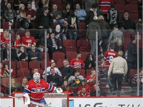 Former Canadiens goalie Mike Condon looks up at the scoreboard as fans head to the exits in the final minutes of National Hockey League game against the Florida Panthers in Montreal Tuesday April 5, 2016.