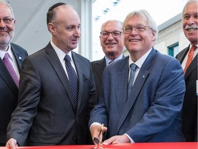 Quebec Health Minister Gaétan Barrette cuts a ceremonial ribbon alongside Jewish General Hospital president Dr. Lawrence Rosenberg, second from left, during a press conference to inaugurate the K Pavilion of the JGH in Montreal on Monday, January 18, 2016.
