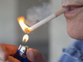 A Montrealer lights up a cigarette.