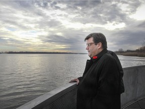 Montreal Mayor Denis Coderre looks at the St. Lawrence River off the shore of Verdun in Montreal Wednesday November 11, 2015--the first day of the sewage dump into the river to allow for repairs to a sewage collector and construction of a new snow chute.