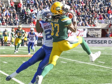 Edmonton Eskimos' Derel Walker makes a catch in front of Montreal Alouettes' Greg Henderson during CFL action at Molson Stadium in Montreal on Monday, Oct. 10, 2016.