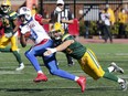 Kenny Stafford is tackled by the Edmonton Eskimos' Neil King during a Canadian Football League game at Molson Stadium in Montreal Monday, Oct. 10, 2016.