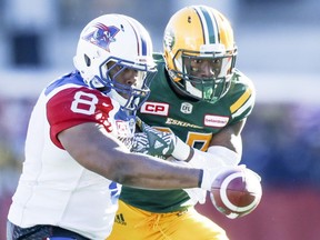 Montreal Alouettes Nik Lewis, left, and Edmonton Eskimos Kenny Ladler fight for football that Lewis had fumbled during Canadian Football League game at Molson Stadium in Montreal Monday October 10, 2016.  The Alouettes kept possession of the ball. (John Mahoney / MONTREAL GAZETTE) ORG XMIT: 57273 - 4449