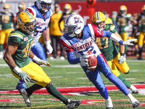 Montreal Alouettes quarterback Rakeem Cato runs away from pressure by Edmonton Eskimos' Deon Lacey during CFL action at Molson Stadium in Montreal on Monday, Oct. 10, 2016.