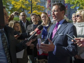Projet Montréal councillor Guillaume Lavoie speaks to journalists in front of Montreal city hall, Monday Oct. 10, 2016, to announce that he'll run for the leadership of the party and run against Mayor Denis Coderre in next year's municipal election.