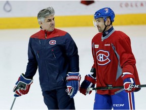 Montreal Canadiens assistant coach Jean-Jacques Daigneault speaks with Montreal Canadiens center Tomas Plekanec during a team practice at the Bell Sports Complex in Montreal on Tuesday October 11, 2016.