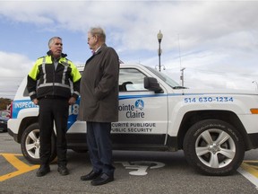 Pointe Claire city inspector Marcel Lamoureux, left, and Mayor Morris Trudeau with an inspector's vehicle in Pointe Claire, October 24, 2016.