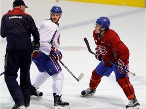Montreal Canadiens centre Torrey Mitchell, and Montreal Canadiens right-winger Brendan Gallagher, right, listen to assistant coach Dan Lacroix as they practice faceoffs during a team practice at the Bell Sports Complex in Montreal on Monday October 17, 2016.