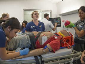 Nursing and pre-hospital emergency care students of John Abbott College go through a dress rehearsal of a multi-vehicle accident.