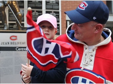 Jayna Kuzee and her father Patrick Kuzee visiting Montreal from the Netherlands, waves the Habs flag as they wait for the Habs season opener in Montreal on Tuesday October 18, 2016.