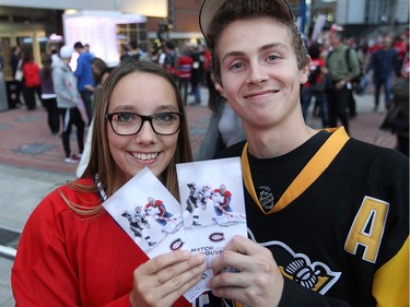 Jessica Thériault and boyfriend Jacob Voyer show their Habs season opener tickets, outside the Bell Centre on Tuesday October 18, 2016.